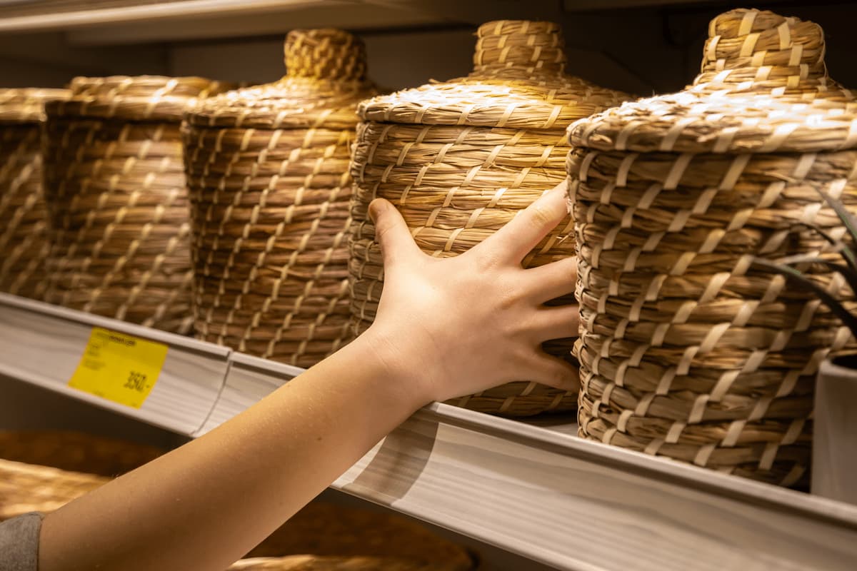 a young woman chooses baskets for a home interior 2025 03 13 16 47 47 utc 1 MimPlas